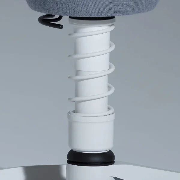 Close-up of the white spring mechanism on an Aeris Swopper Ergonomic Office Stool.