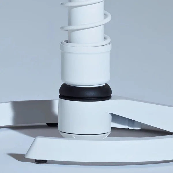 Close-up of the white Aeris Swopper ergonomic stool base with glides