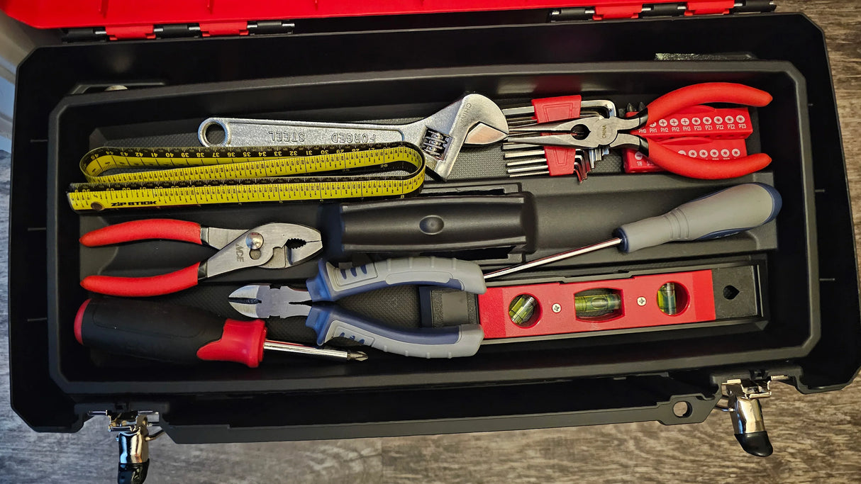 Toolbox with various tools including pliers, wrenches, a 36" Zip Stick ProSpan, and screwdrivers on a wooden surface.