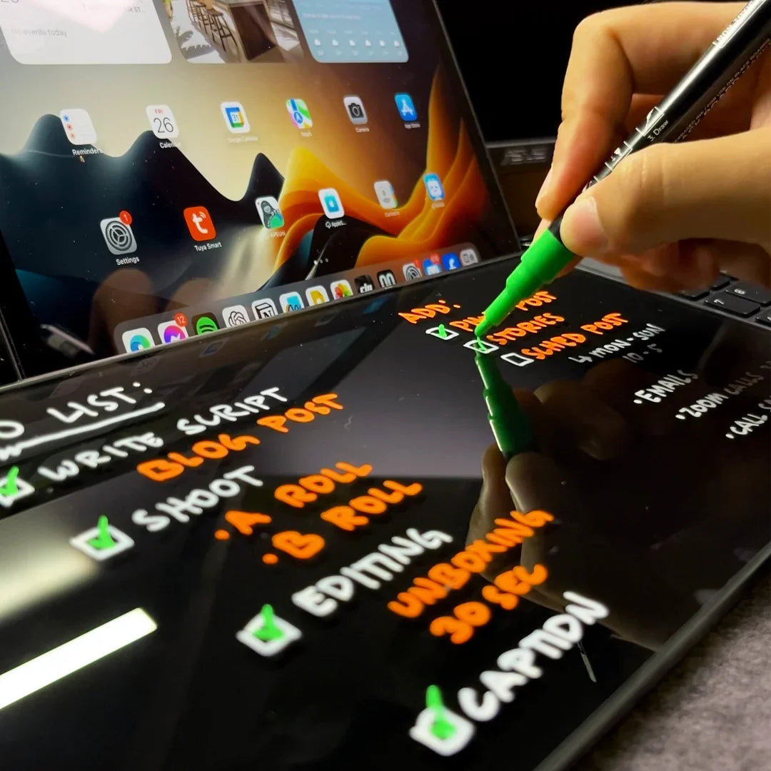 Hand writing digital to-do list with stylus on tablet, productivity workspace, laptop and tablet