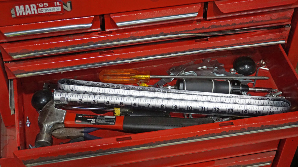 Victor® Zip Stick 72 inch ProSpan magnetic measuring tool and assorted hand tools in a red toolbox.