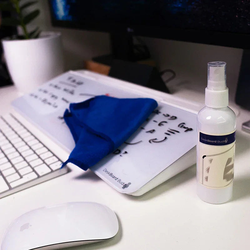 Desk whiteboard with cleaning spray, blue cloth, keyboard, and mouse on office desk