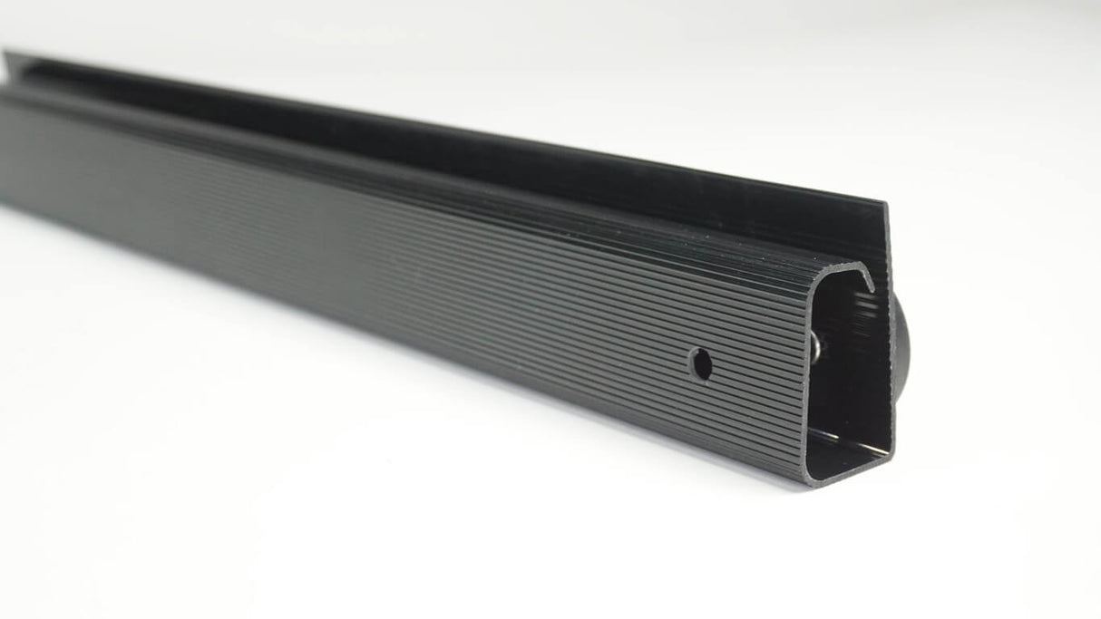Black metal strip with textured surface on a white background