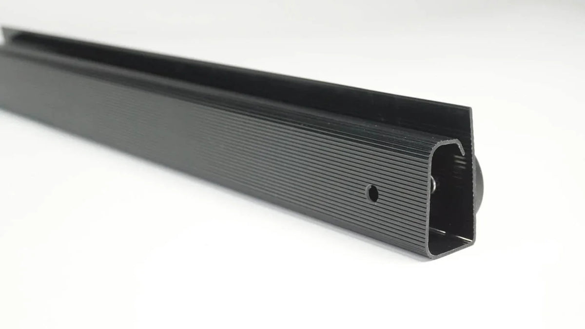 Close-up of a black Officemate® MagnetPlus magnetic cable raceway.