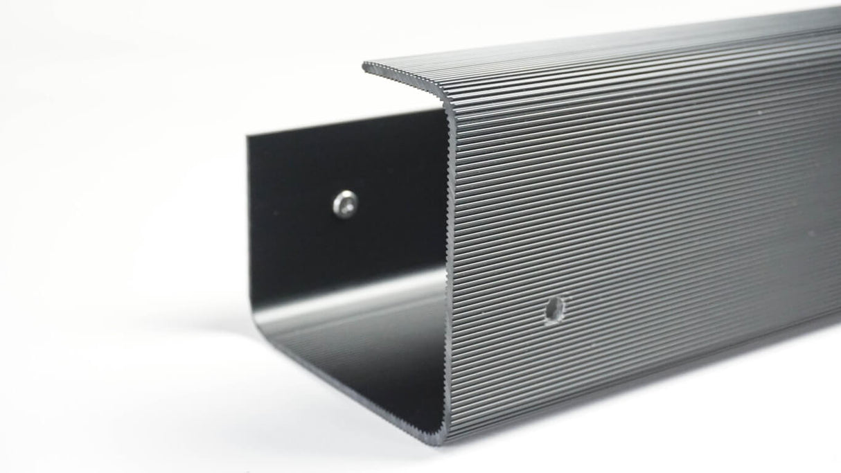 Metallic strip with a ribbed surface on a white background