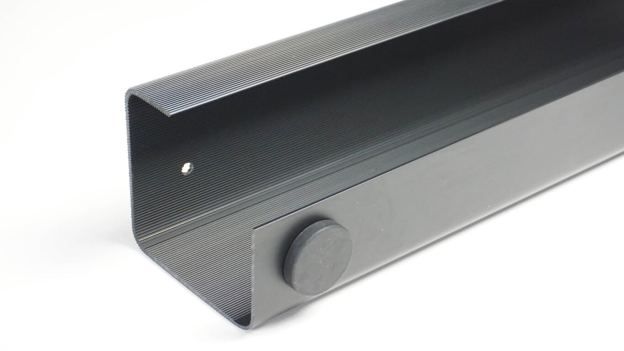 Gray soundbar with a control knob on a white background