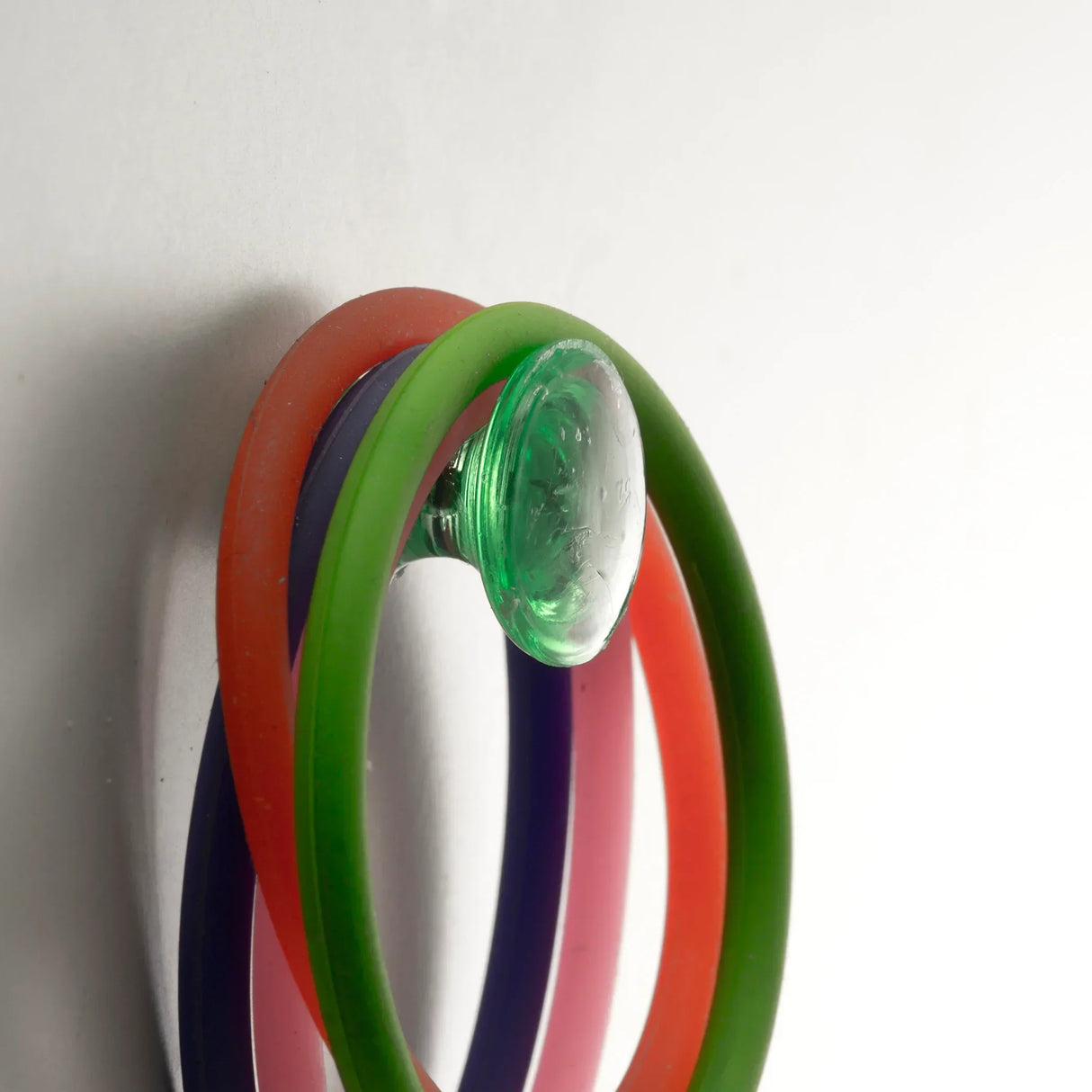 Colorful silicone wristbands with green glass bead, ideal for office or school use
