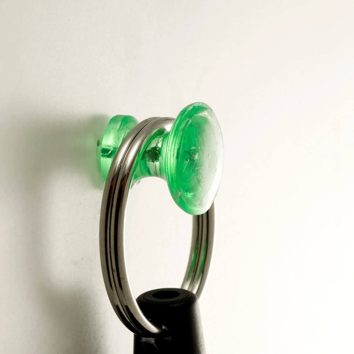 Green suction cup with metal ring attached to a black handle