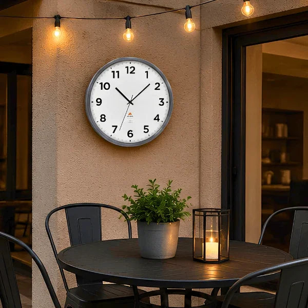 Alba Extra Inoxydable silver grey indoor outdoor wall clock on a patio wall