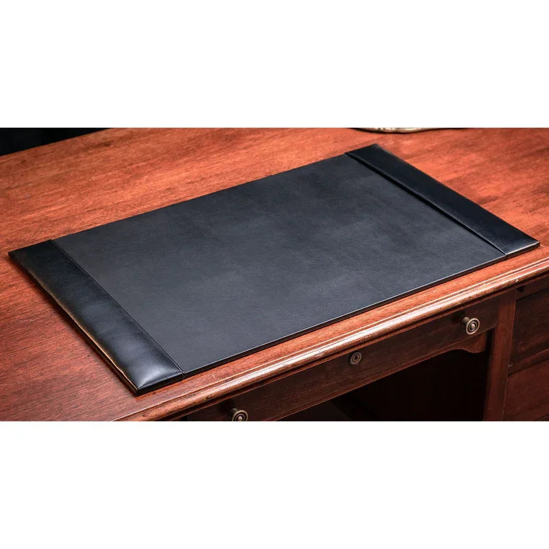 Black bonded leather 30x18 desk pad on a wooden office desk