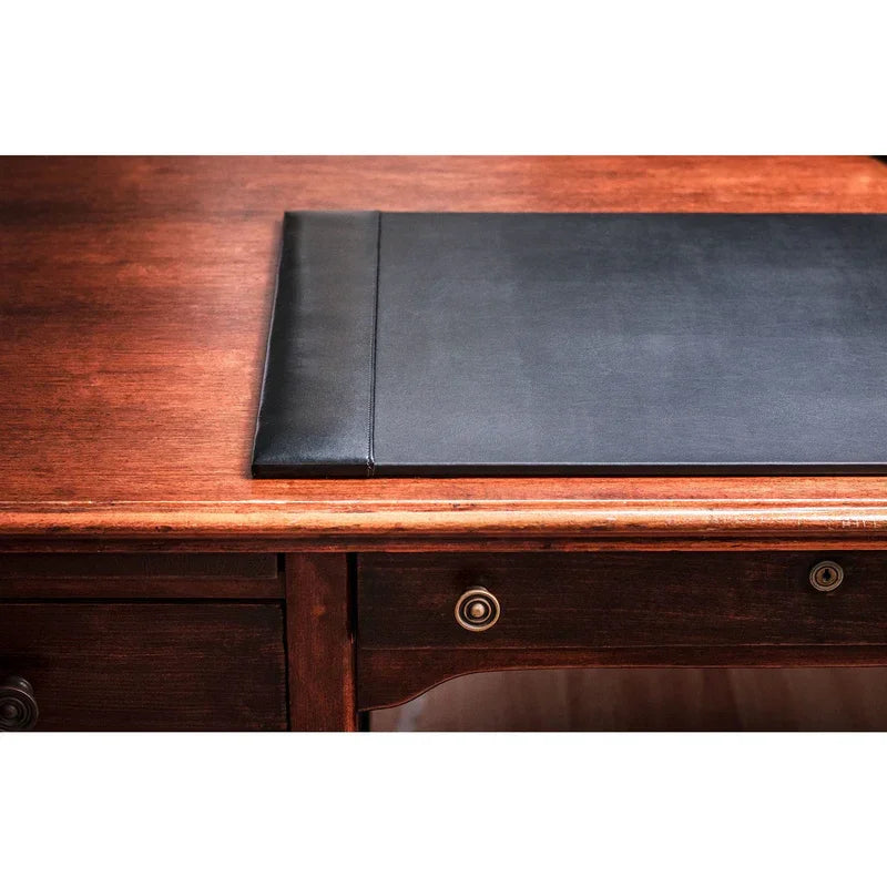 Black bonded leather desk pad on wooden desk surface, office workspace accessory