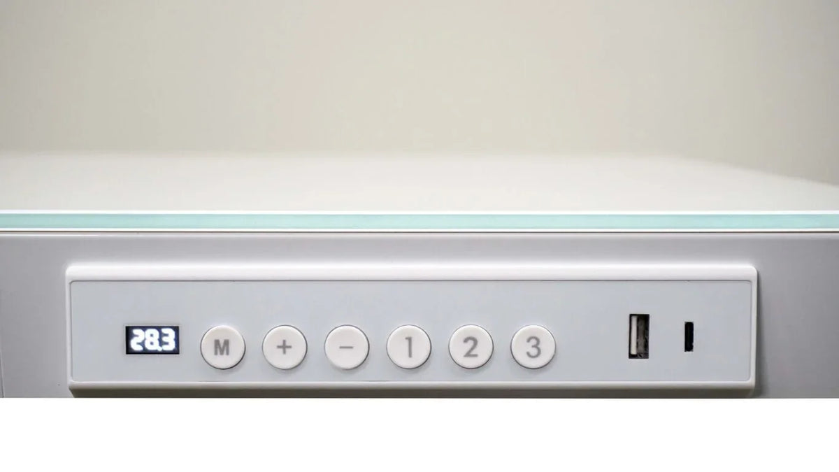 Digital control panel of a Victor® Electric Glass Topped Standing Desk with height display.