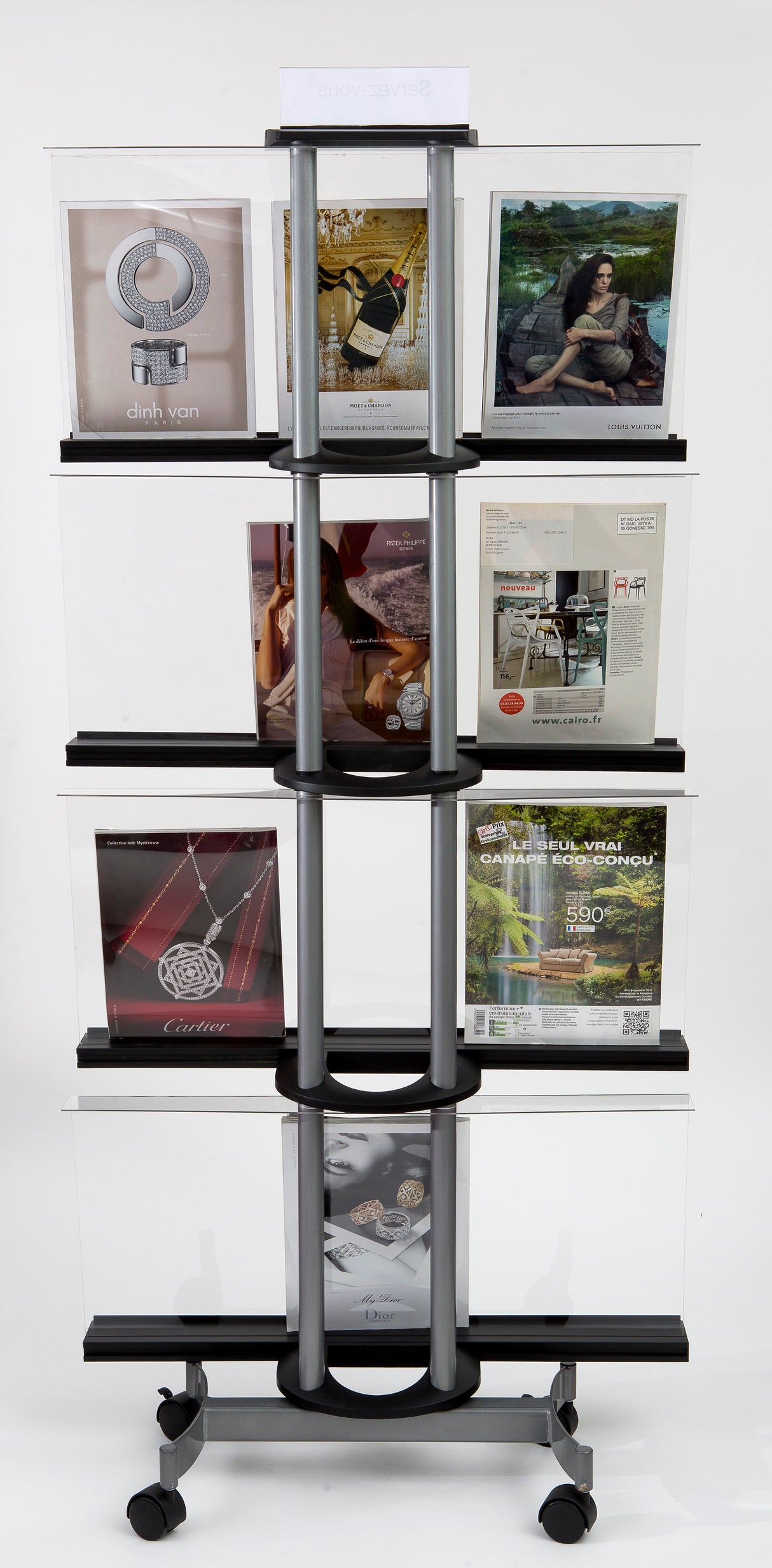 Rolling magazine display rack with multiple shelves holding brochures and catalogs