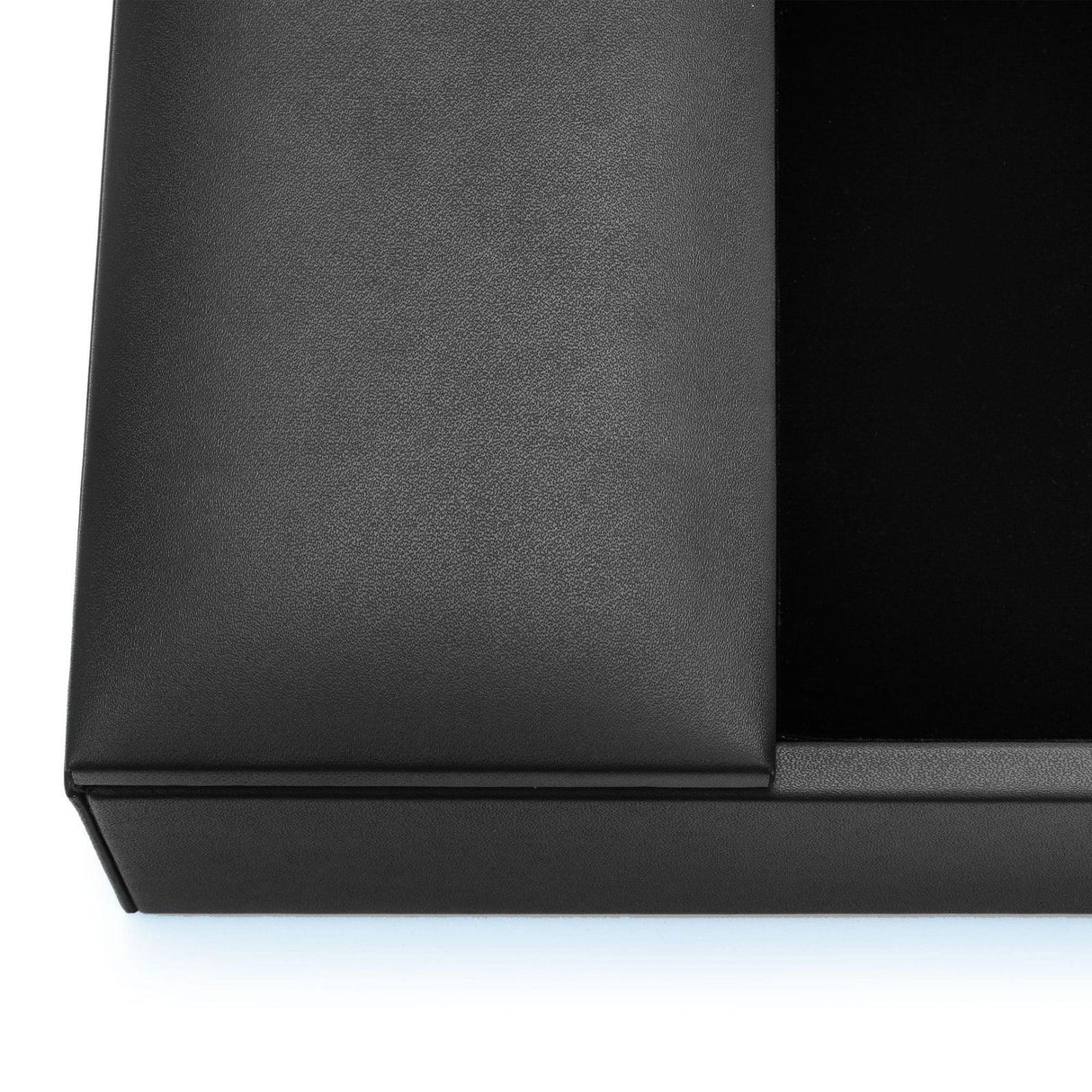 Close-up of black leather conference room organizer box corner on white background