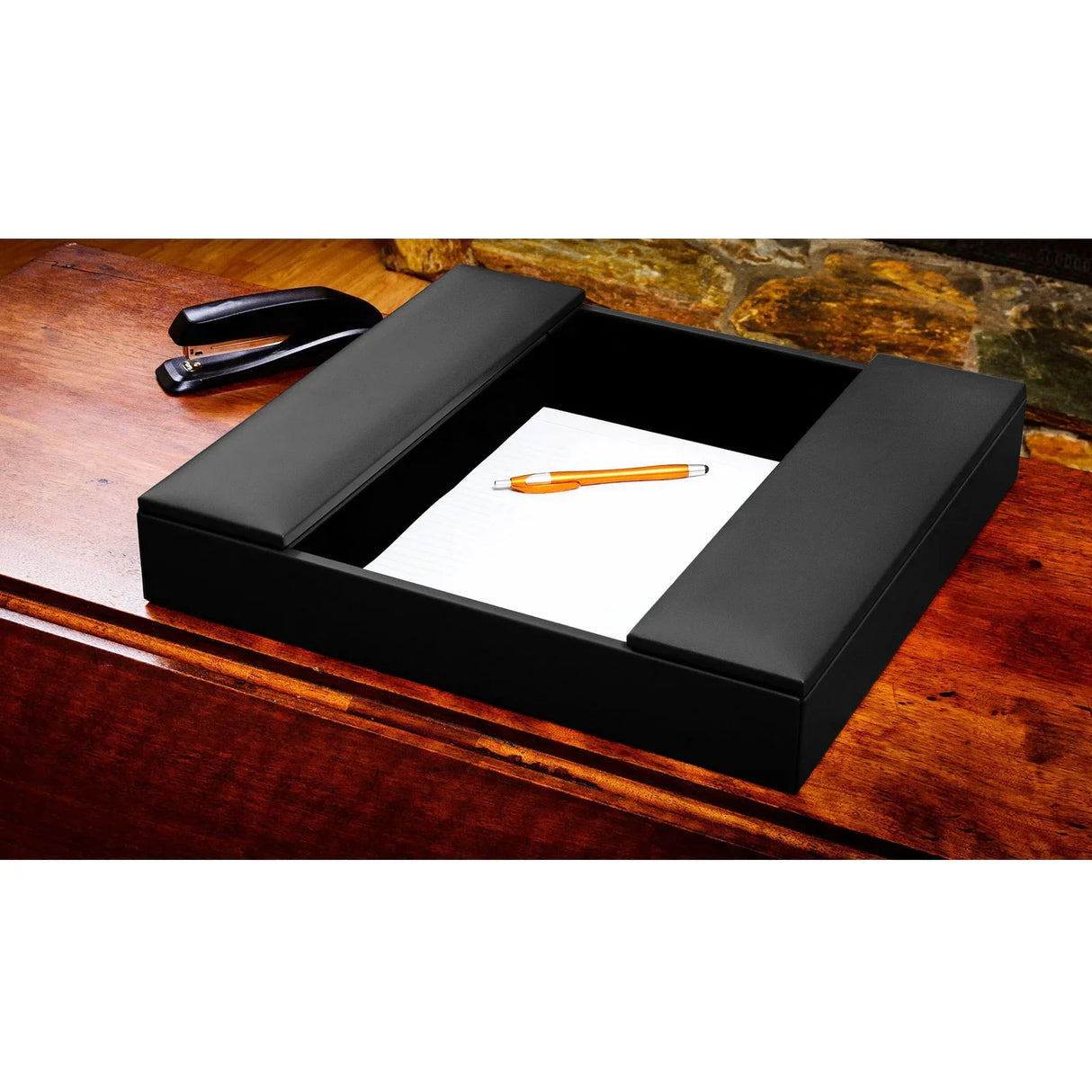 Black leather conference room organizer tray with notepad and pen on wooden desk