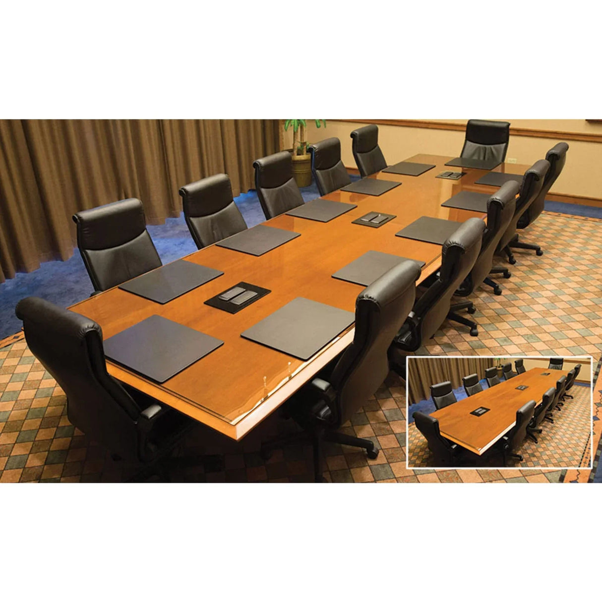 Conference room table with black leatherette desk pads and executive chairs