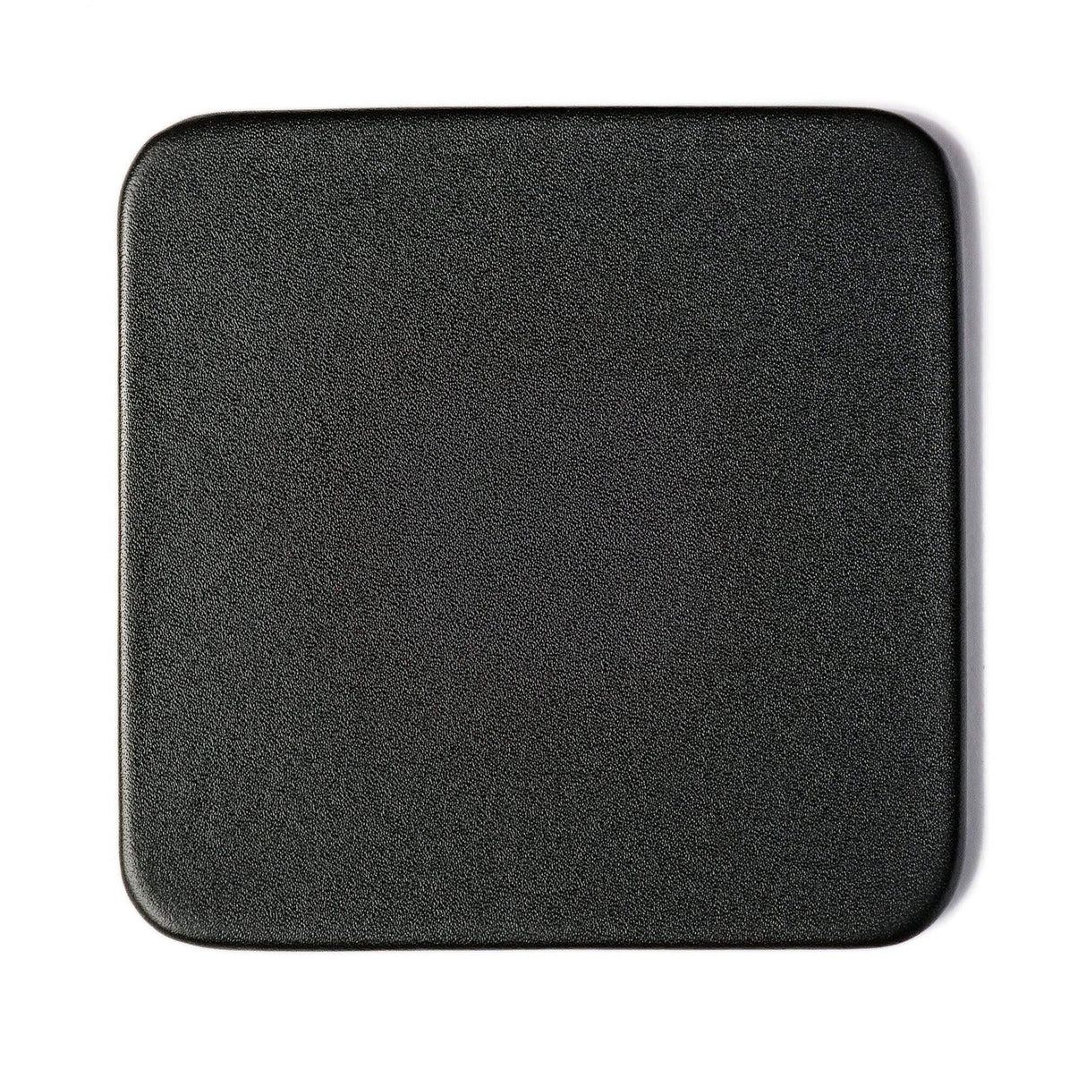 Black square leatherette coaster with rounded edges, textured surface