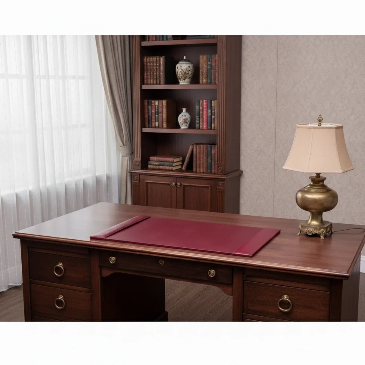 Burgundy leather desk pad on executive wooden desk in classic office setting
