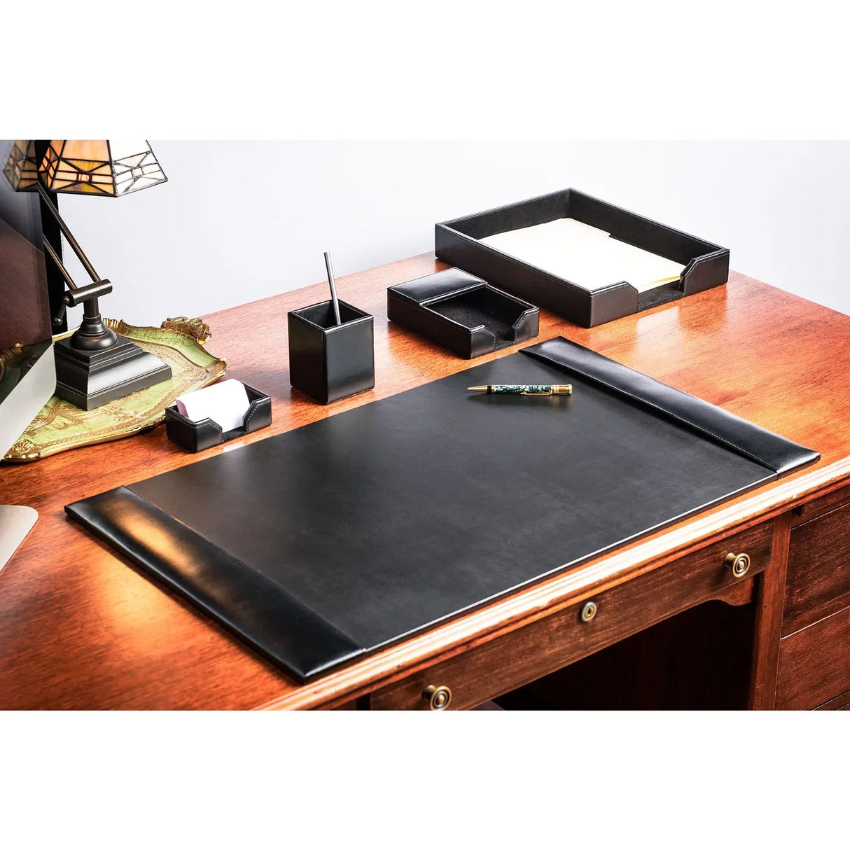 Black bonded leather 5-piece desk set with mat, tray, pen holder, and organizer on wood desk