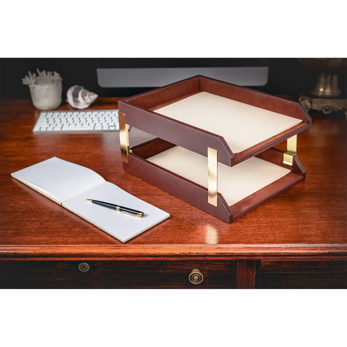 Chocolate brown leather double letter tray with gold accents on an organized wooden desk
