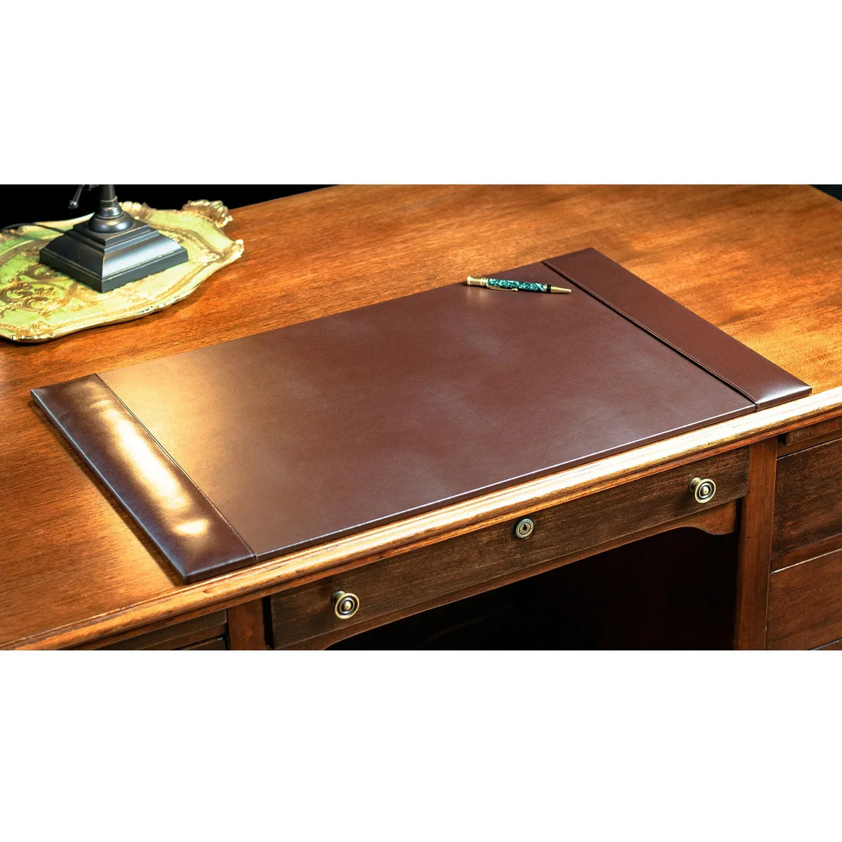Dark brown bonded leather desk pad on wooden office desk with pen and lamp tray