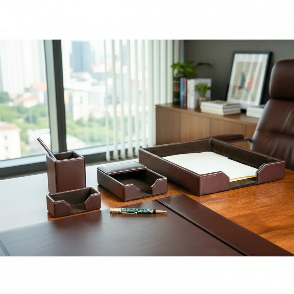Dark brown leather desk organizer set on executive office desk with city view window