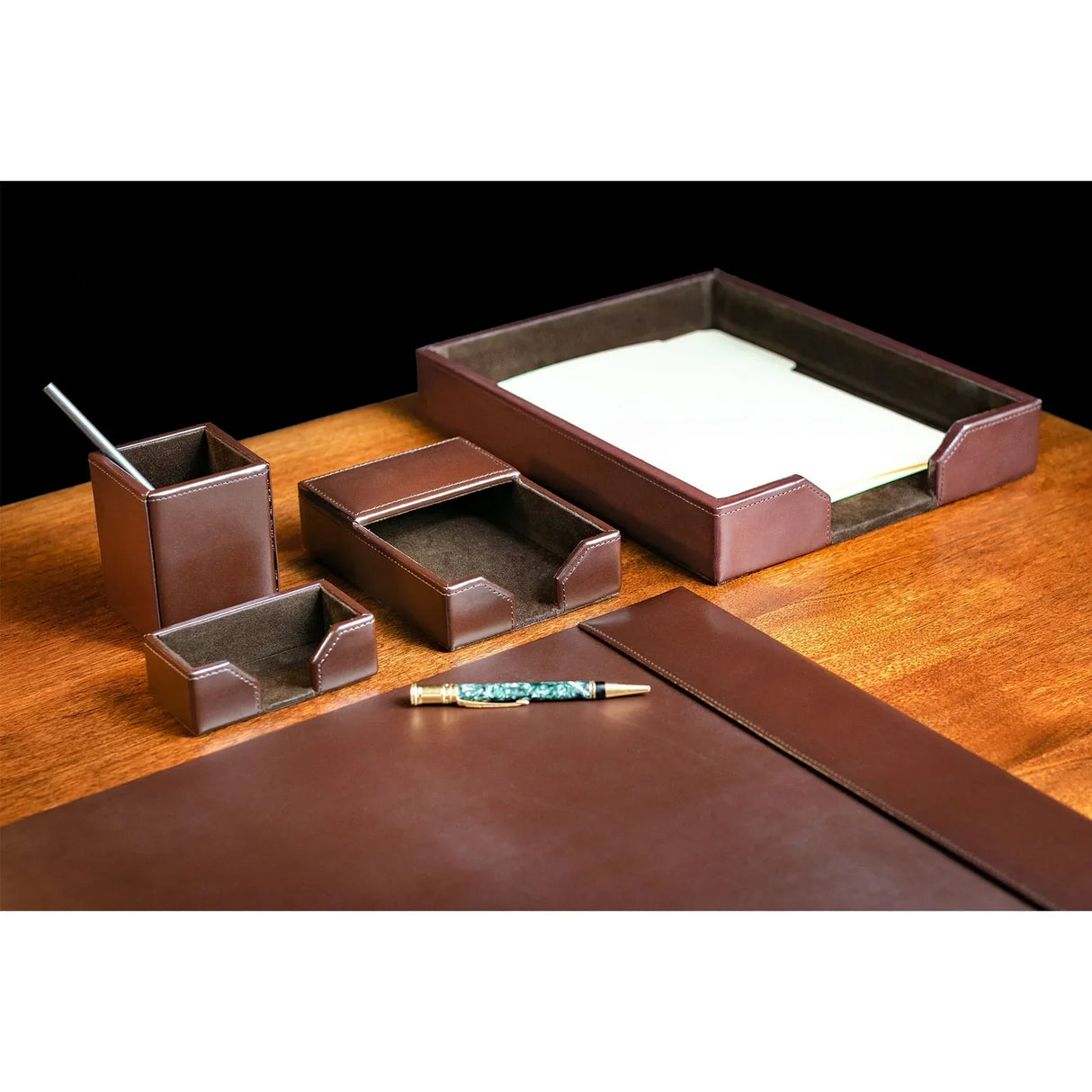 Dark brown leather desk organizer set with tray, pen holder and letter holder on wood desk