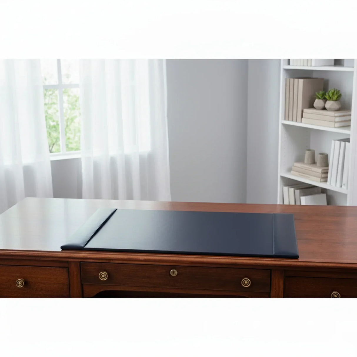 Navy blue leather desk pad on wooden office desk in a bright, organized workspace