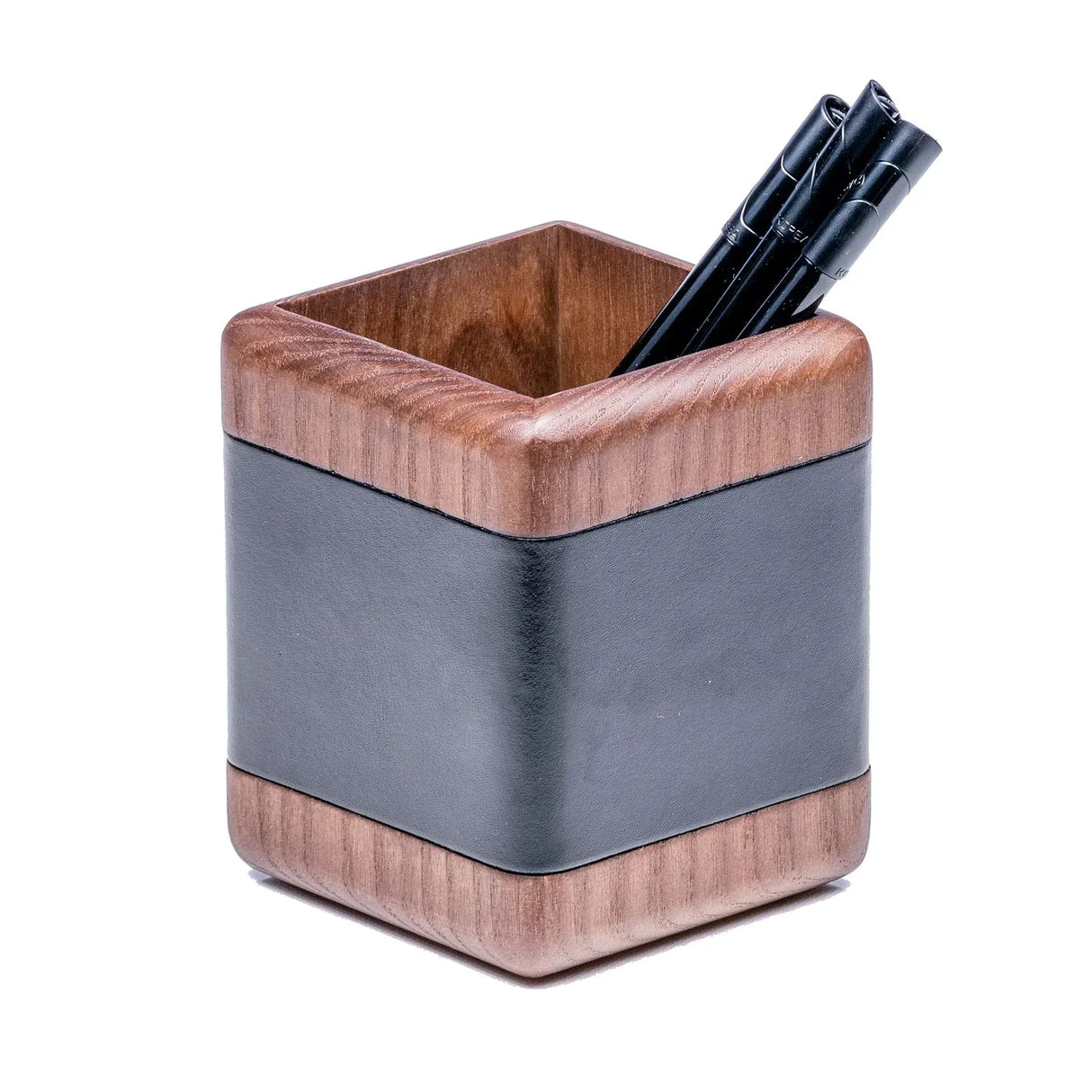 Walnut wood and black leather pencil holder with pens, modern office desk organizer.