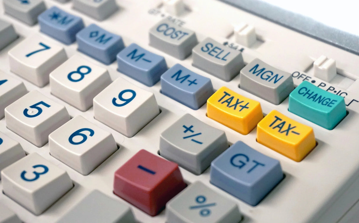 Close-up of calculator keypad with tax, cost, and change function keys, office equipment