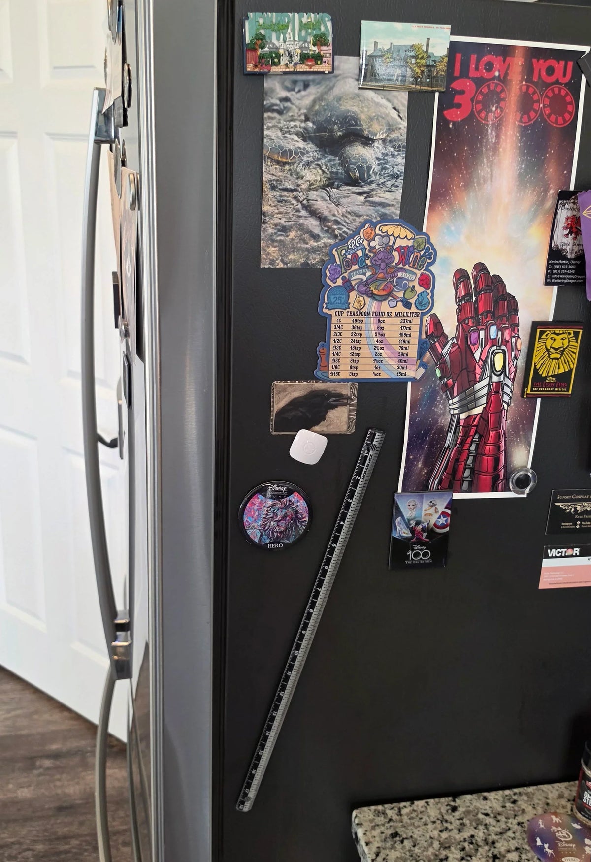 Victor® 18-inch magnetic ruler attached to a refrigerator with various magnets and stickers.