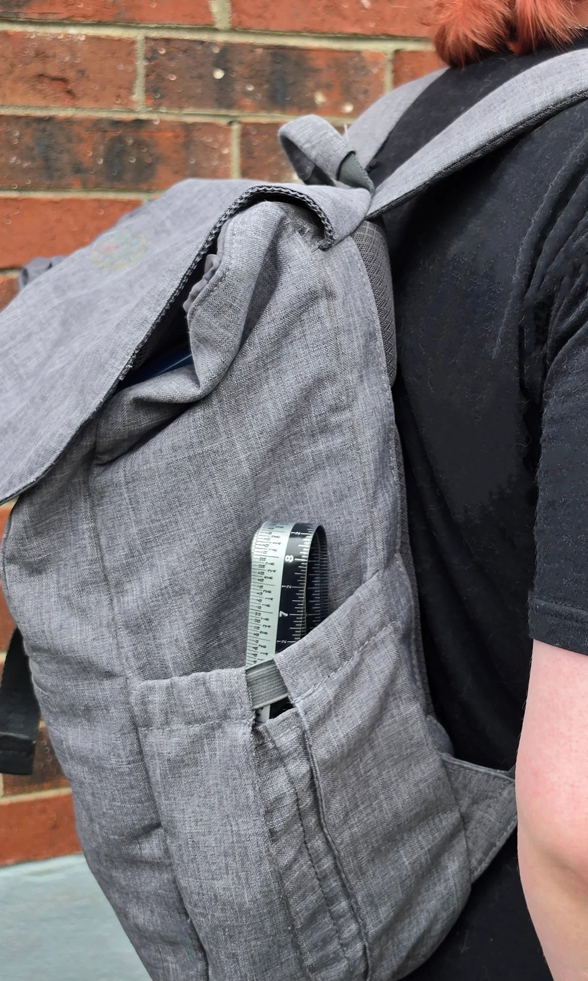 Victor Zip Stick 36 inch ProSpan magnetic measuring tool tucked into a gray backpack pocket.