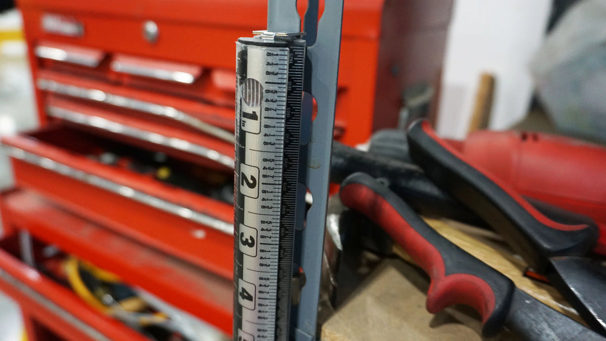 Victor ProSpan magnetic measuring tool attached to a metal tool chest near red-handled tools