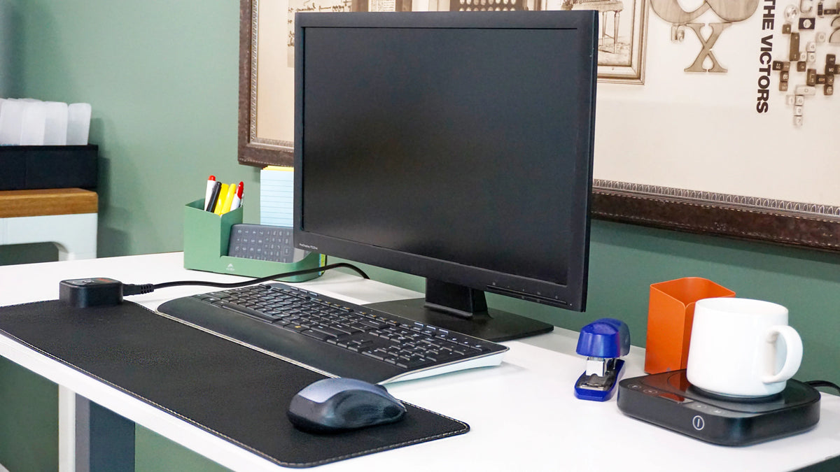 Victor Heetz small grounding desk pad with keyboard and mouse on a white office desk