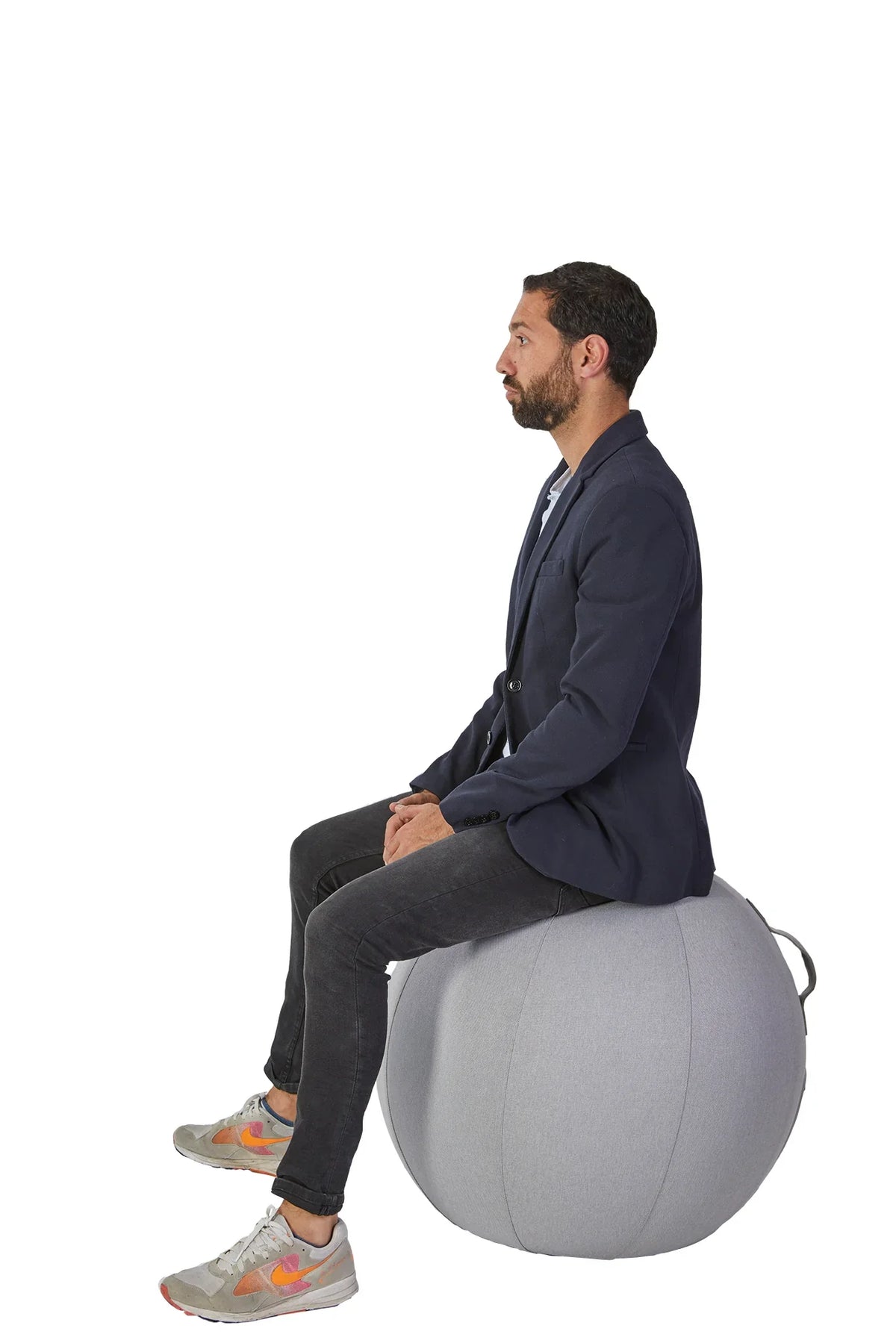 Man sitting on a grey Alba MoveHop Ergonomic Seat Ball