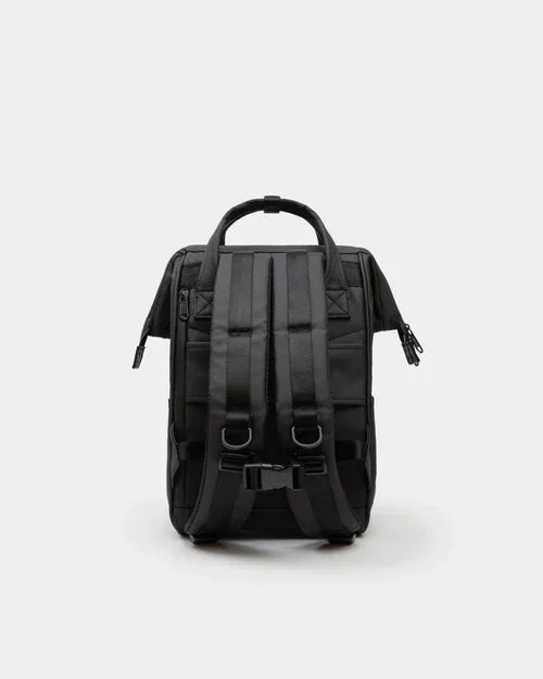 Black compact backpack with adjustable padded shoulder straps and top handle, rear view