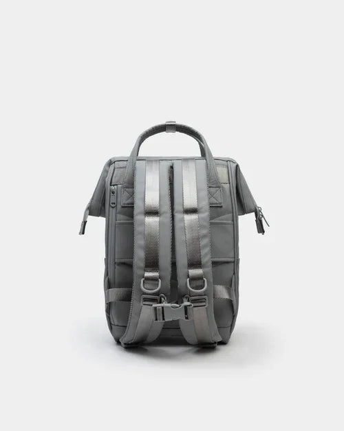 Compact gray backpack with padded shoulder straps and top handle, shown from the back on a light background