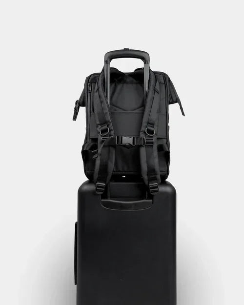 Black rolling suitcase with backpack attached, ideal for travel or commuting