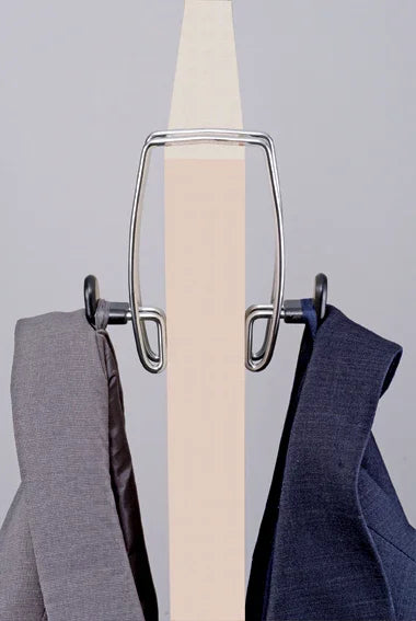 Metal coat hook mounted on a wooden surface holding two suit jackets, office organizer
