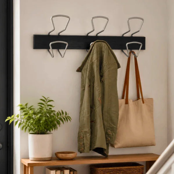 Alba Juxtaposable Wall Coat Peg Rack with an olive green jacket and tan tote bag.