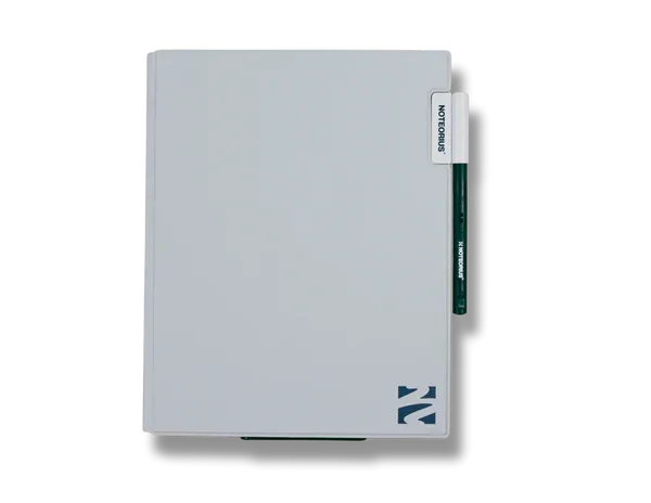 White reusable notebook with pen and labeled tab, placed on plain background
