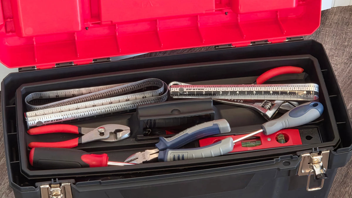 Zip Stick 18" magnetic ruler and various hand tools inside a black toolbox.