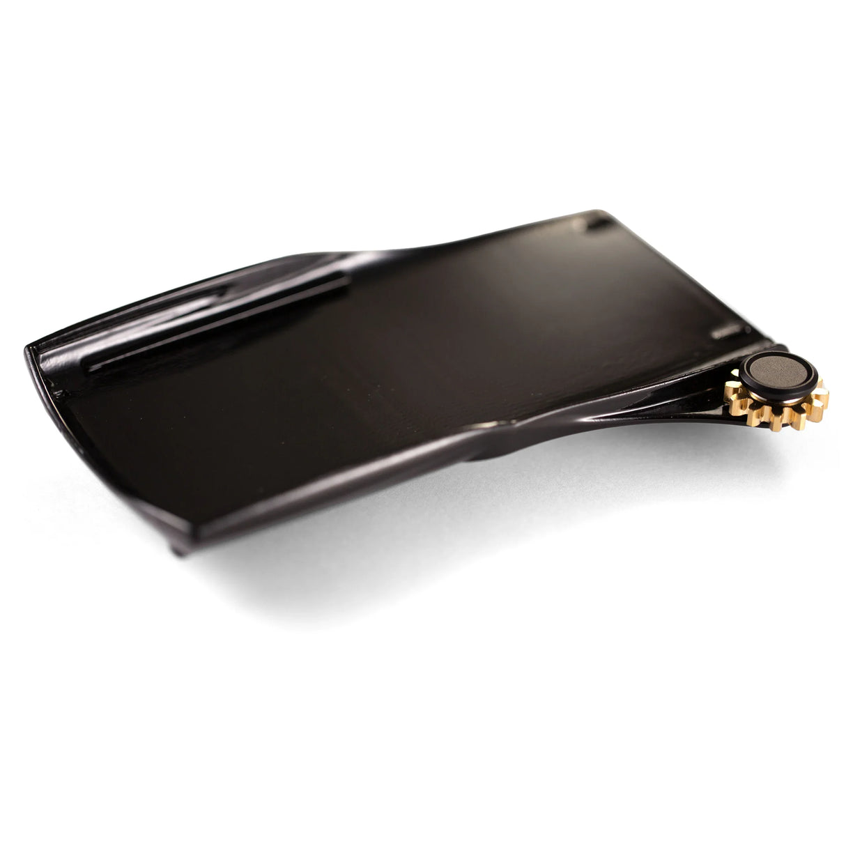 Black plastic calculator paper holder replacement part with gold gear, isolated on white background