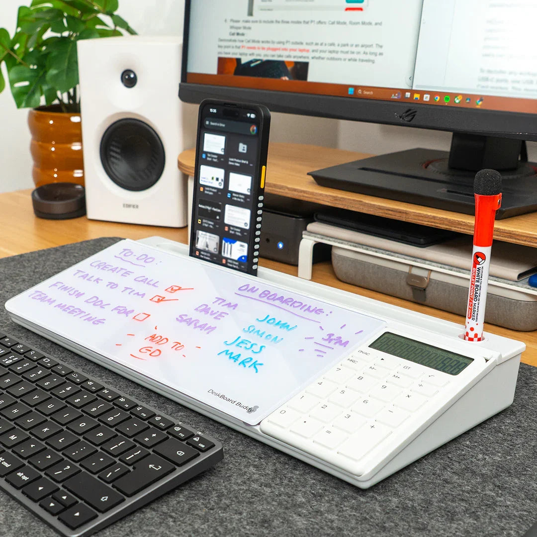 Desktop whiteboard organizer with calculator, phone holder, marker, and to-do list near computer