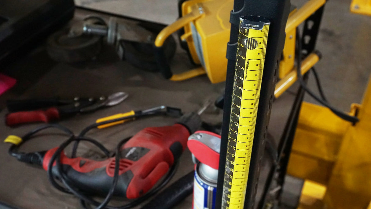 Close-up of a Zip Stick with tools and equipment in the background