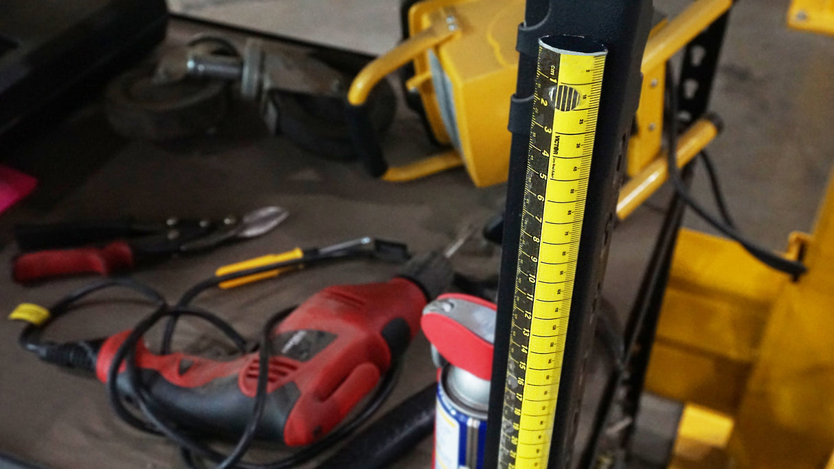 Close-up of a Zip Stick with tools and equipment in the background