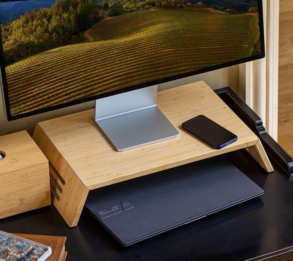 Bamboo monitor stand on desk with computer monitor and smartphone, workspace organizer