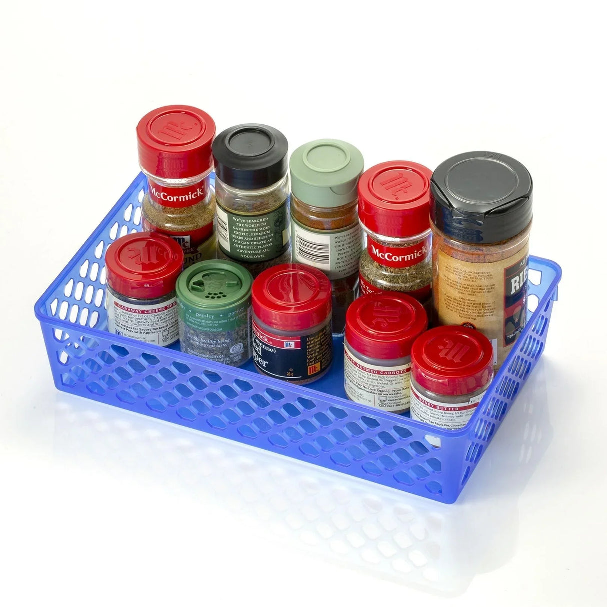Large blue plastic supply basket holding assorted spice jars on white background