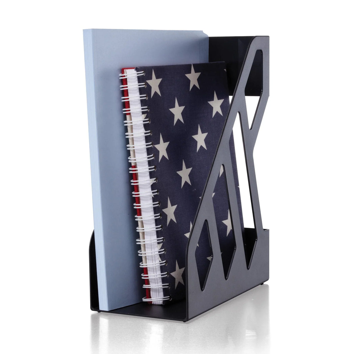 Black magazine file holder with a blue folder and star-patterned spiral notebook