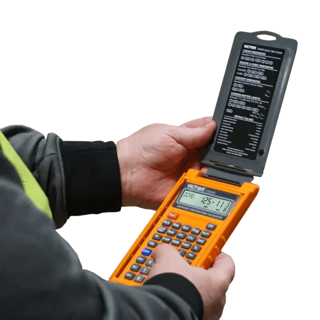Person using an orange advanced construction calculator with flip cover and reference guide.